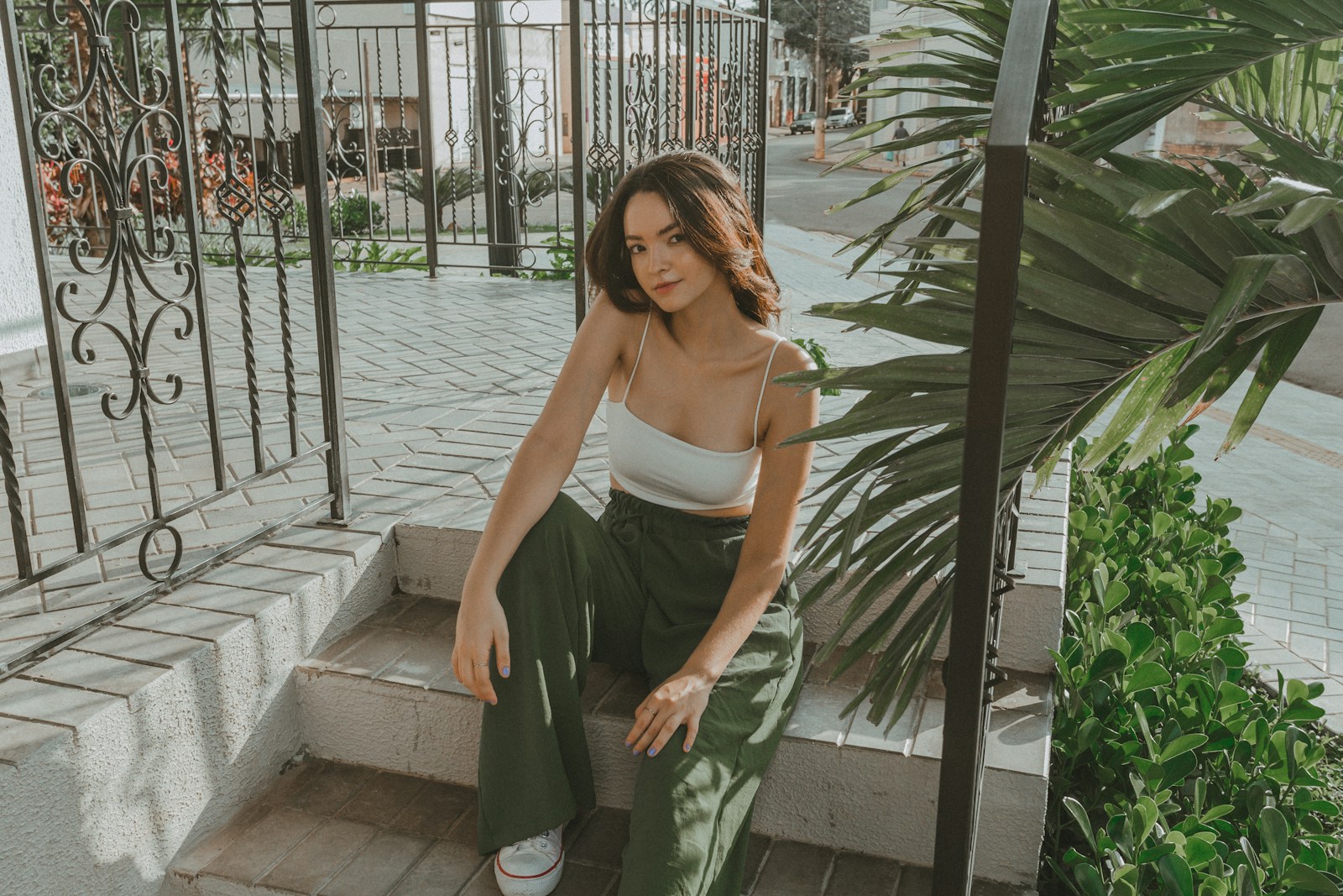 a woman is sitting on the steps of a house