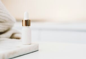 white drop bottle on white surface