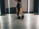 woman in black tank top and black leggings standing on white floor
